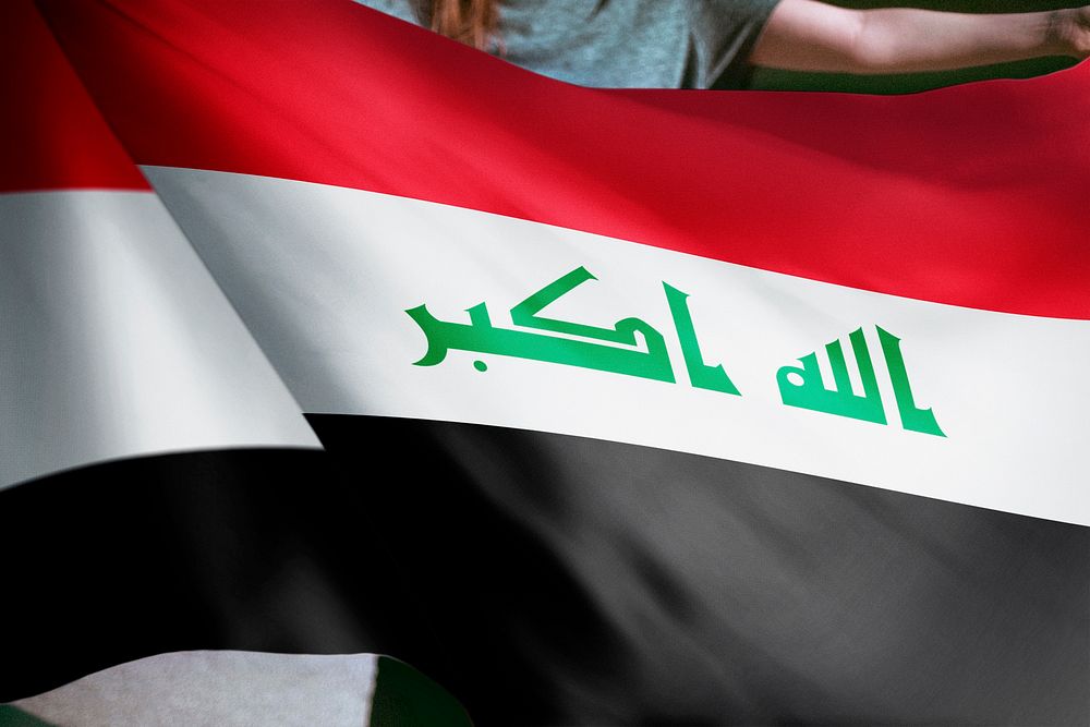 Person holding Iraq flag background, national symbol