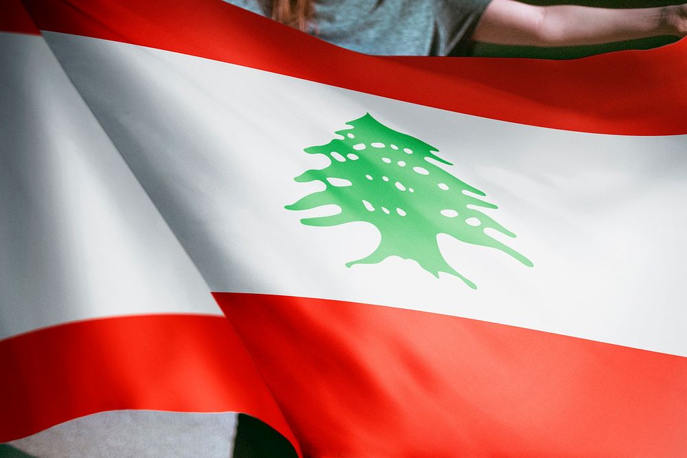 Person holding Lebanese flag background, national symbol