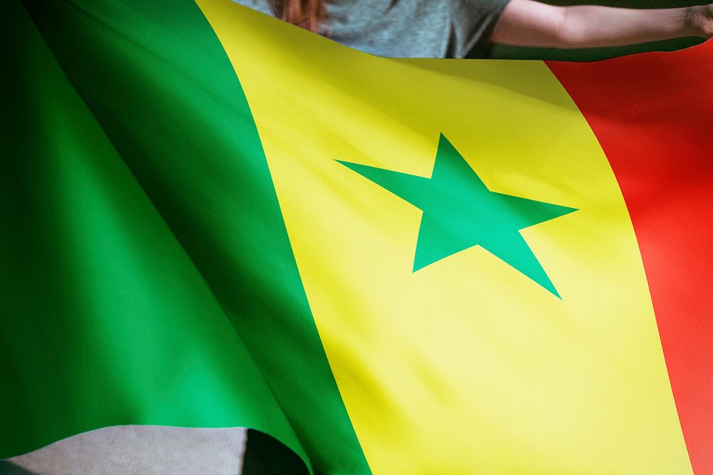 Person holding Senegal flag background, national symbol