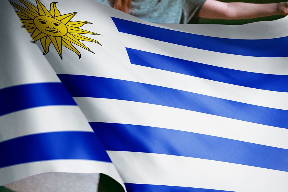 Person holding Uruguay flag background, national symbol