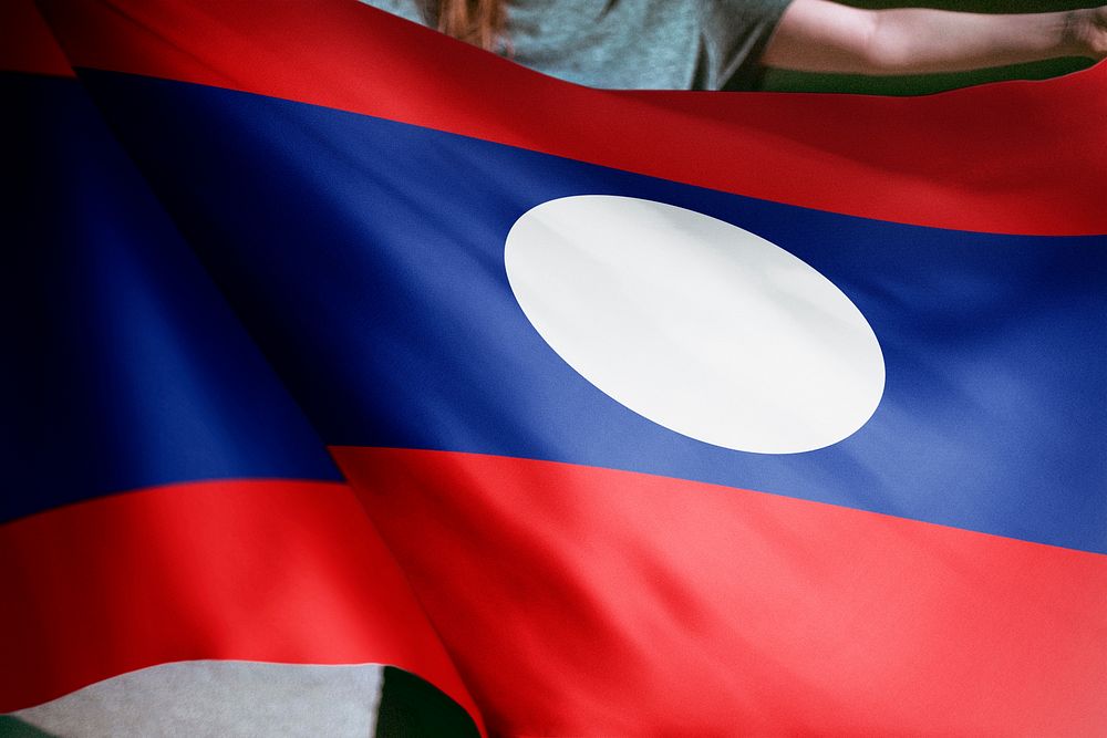 Person holding Laos flag background, national symbol