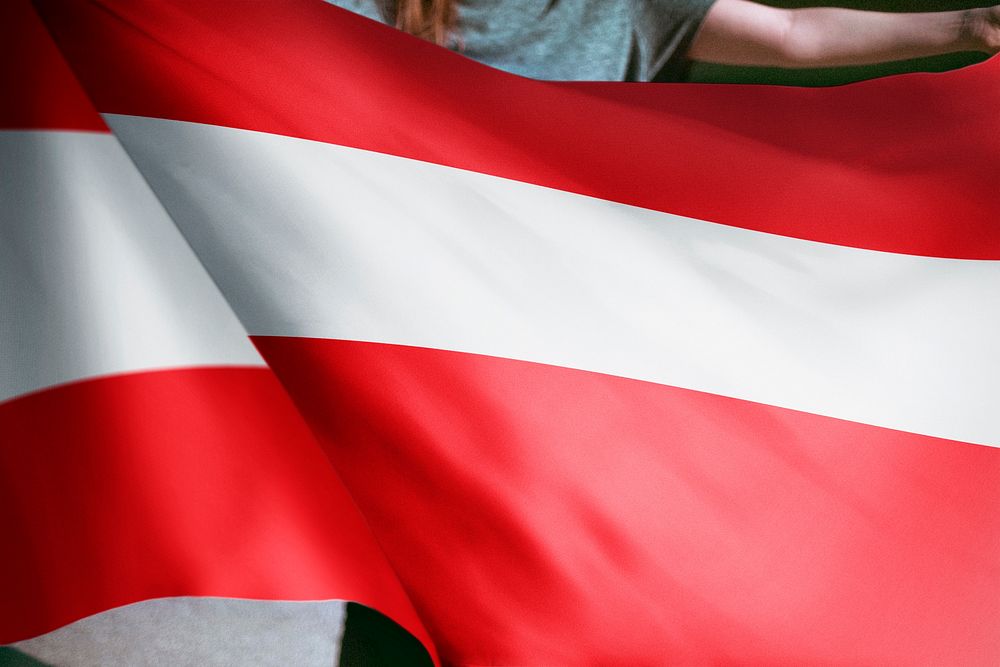 Person holding Austria flag background, national symbol