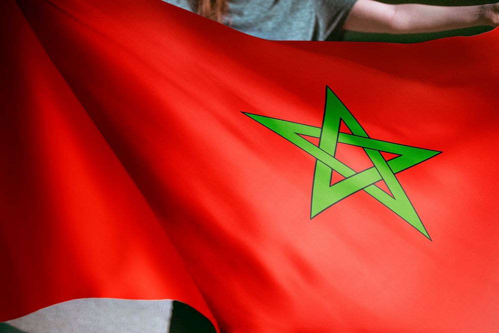 Person holding Morocco flag background, national symbol