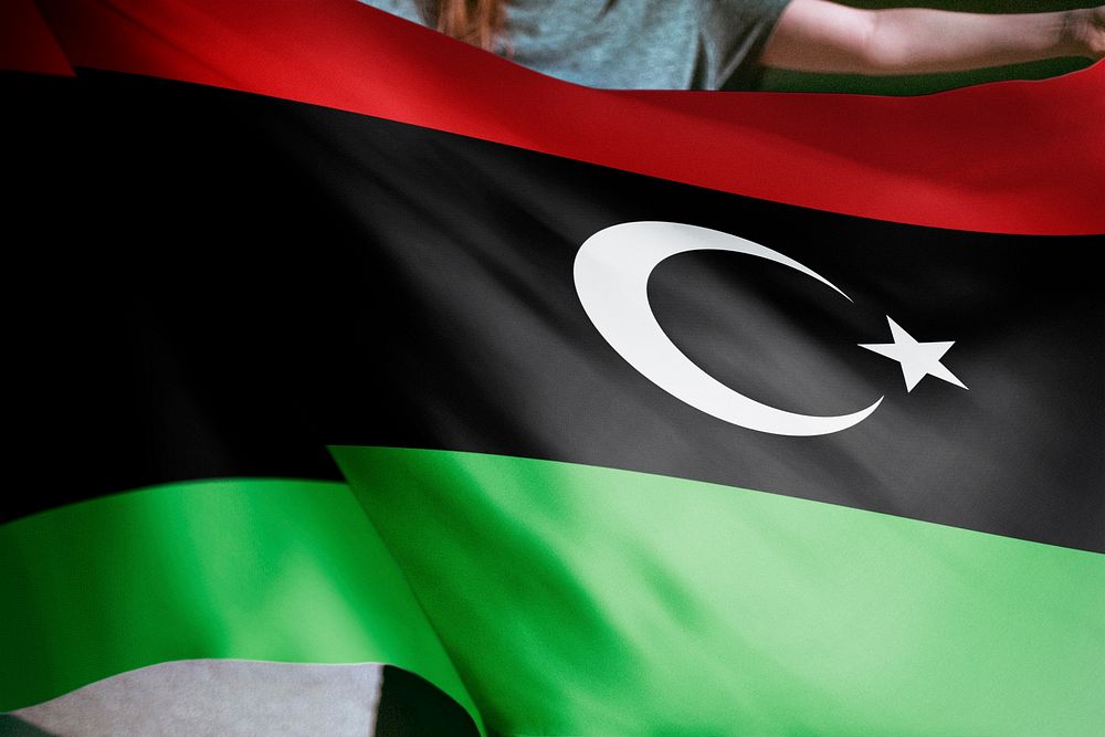 Person holding Libya flag background, national symbol