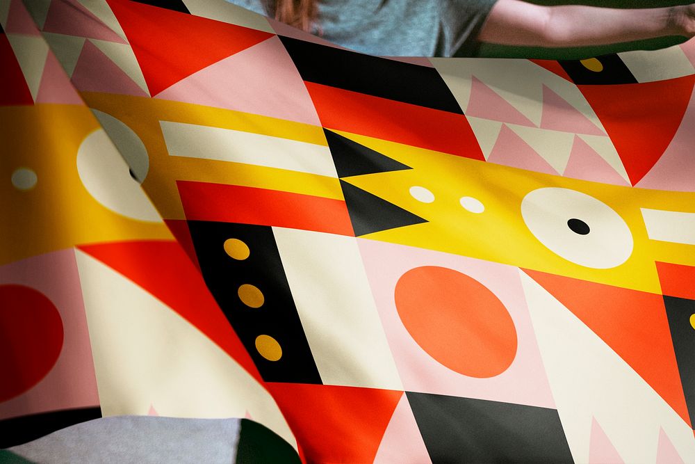 Person holding Bauhaus inspired patterned flag background