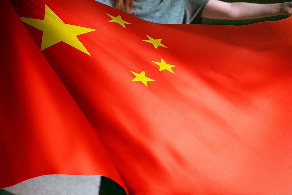 Person holding Chinese flag background, national symbol