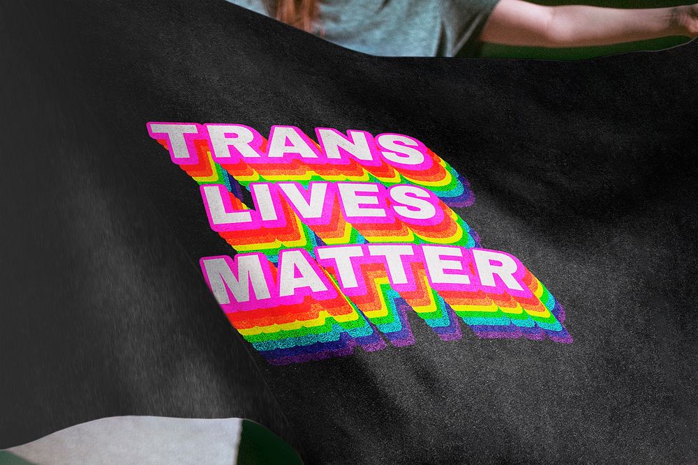 Person holding black flag background, trans lives matters text