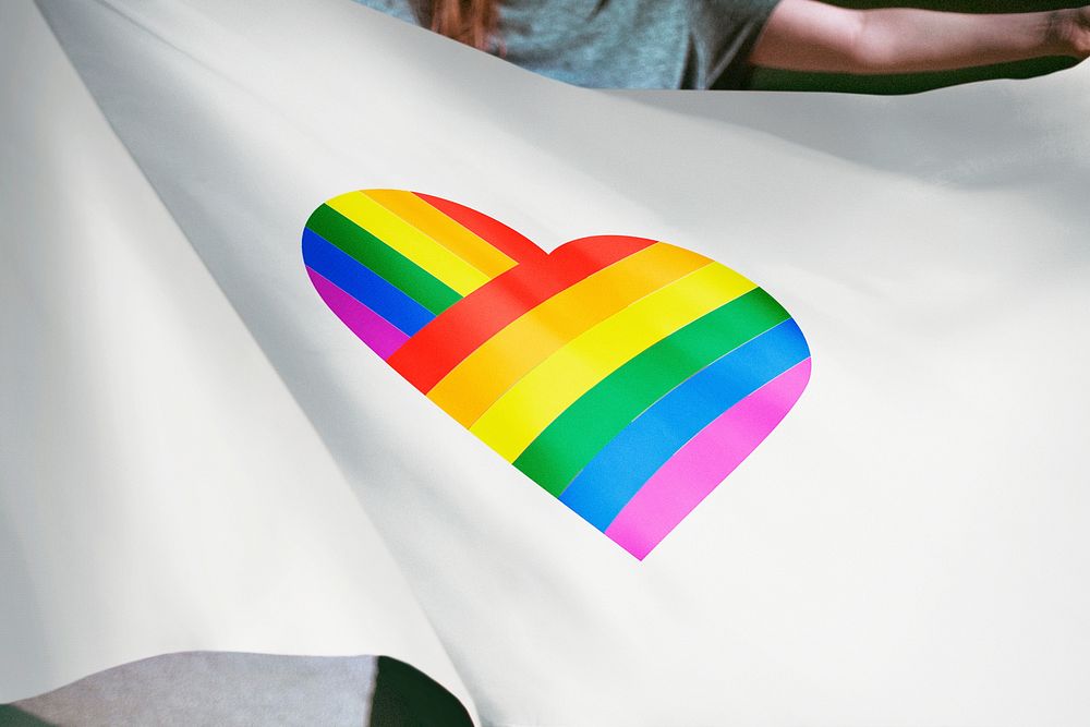 Person holding pride LGBTQ heart flag background