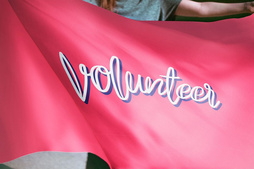 Person holding pink volunteer flag