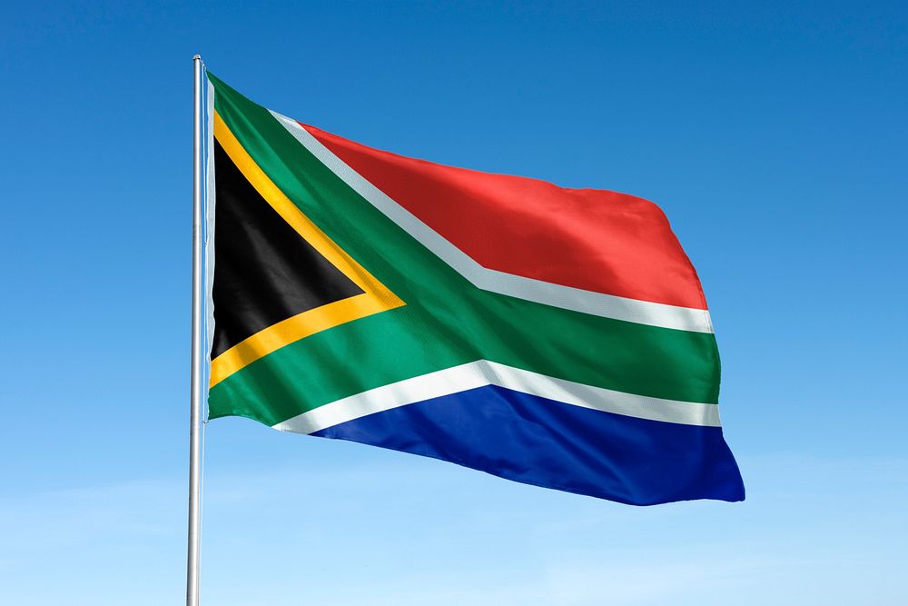 Waving South African flag, national symbol, blue sky
