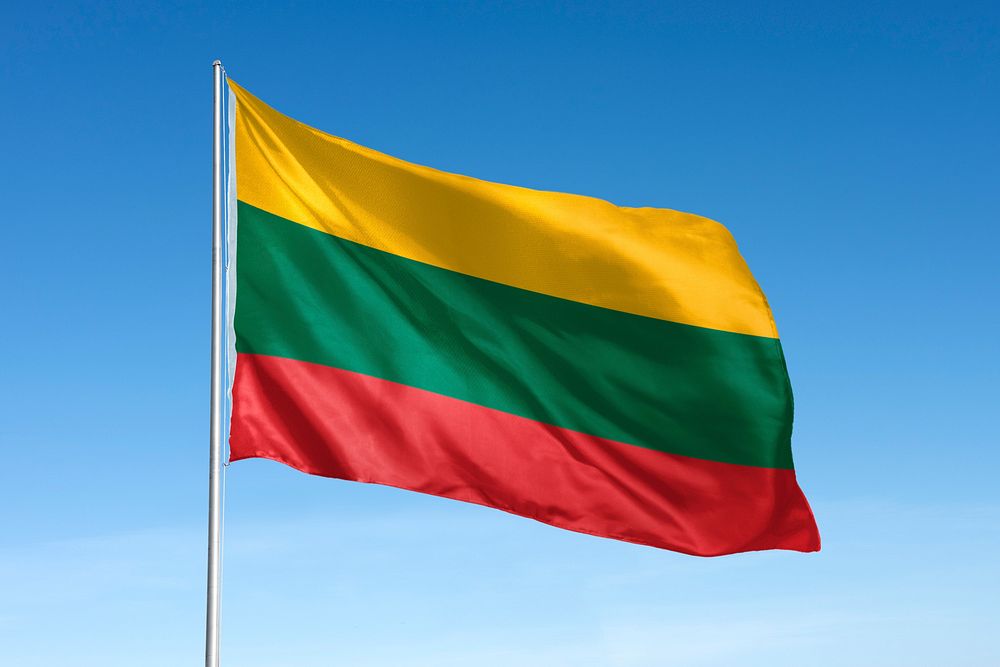 Waving Lithuania flag, national symbol, blue sky