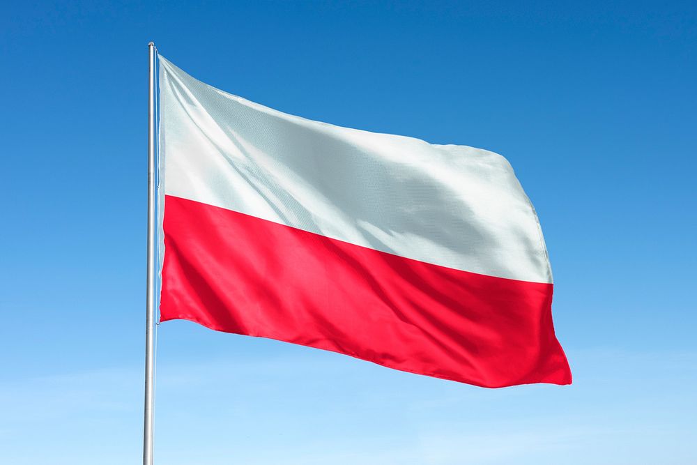 Waving Poland flag, national symbol, blue sky