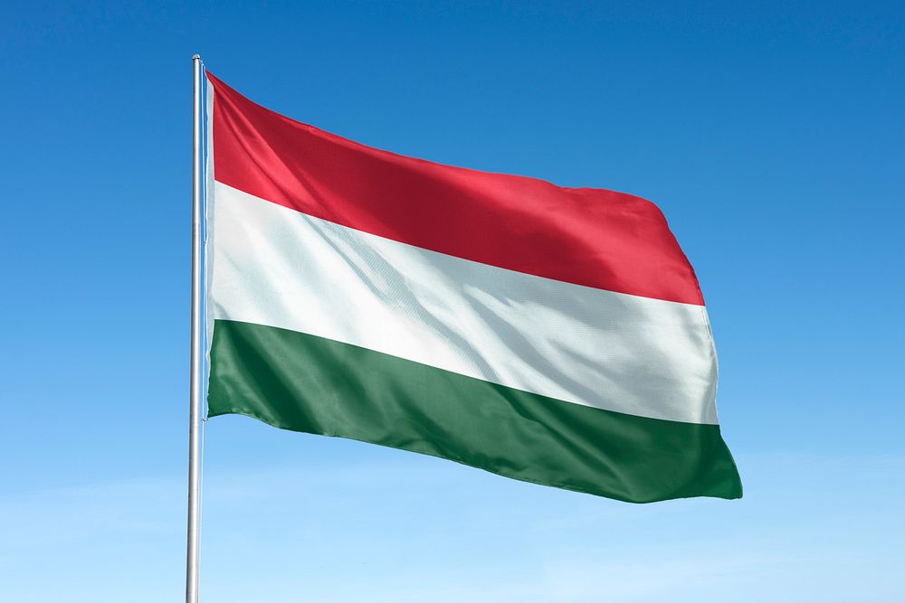 Waving Hungary flag, national symbol, blue sky