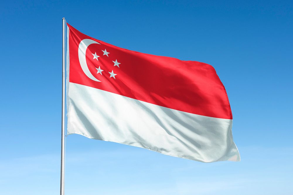 Waving Singapore flag, national symbol, blue sky