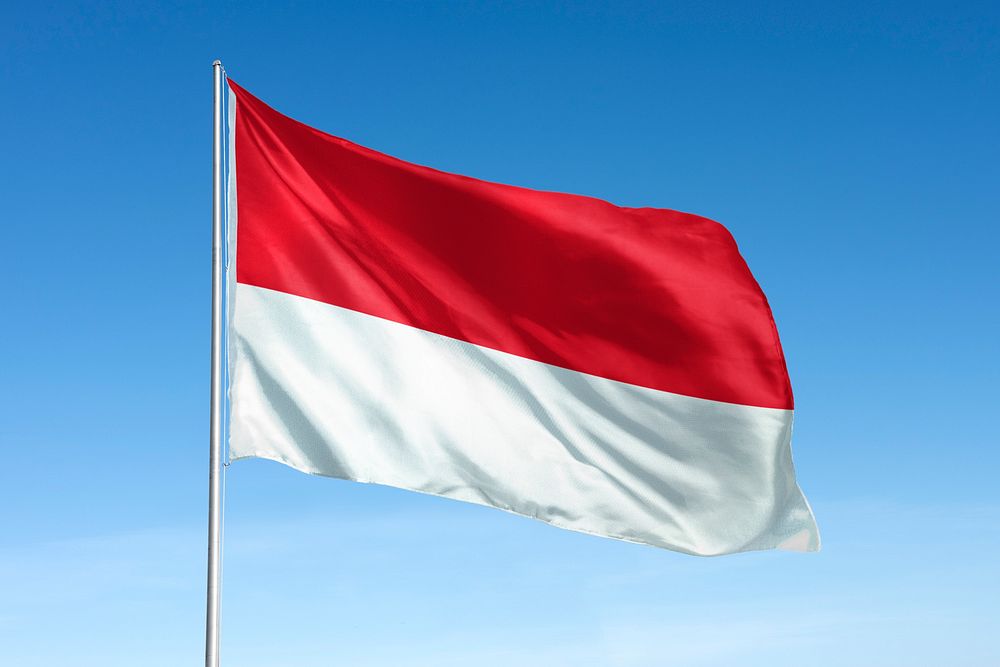 Waving Indonesia flag, national symbol, blue sky