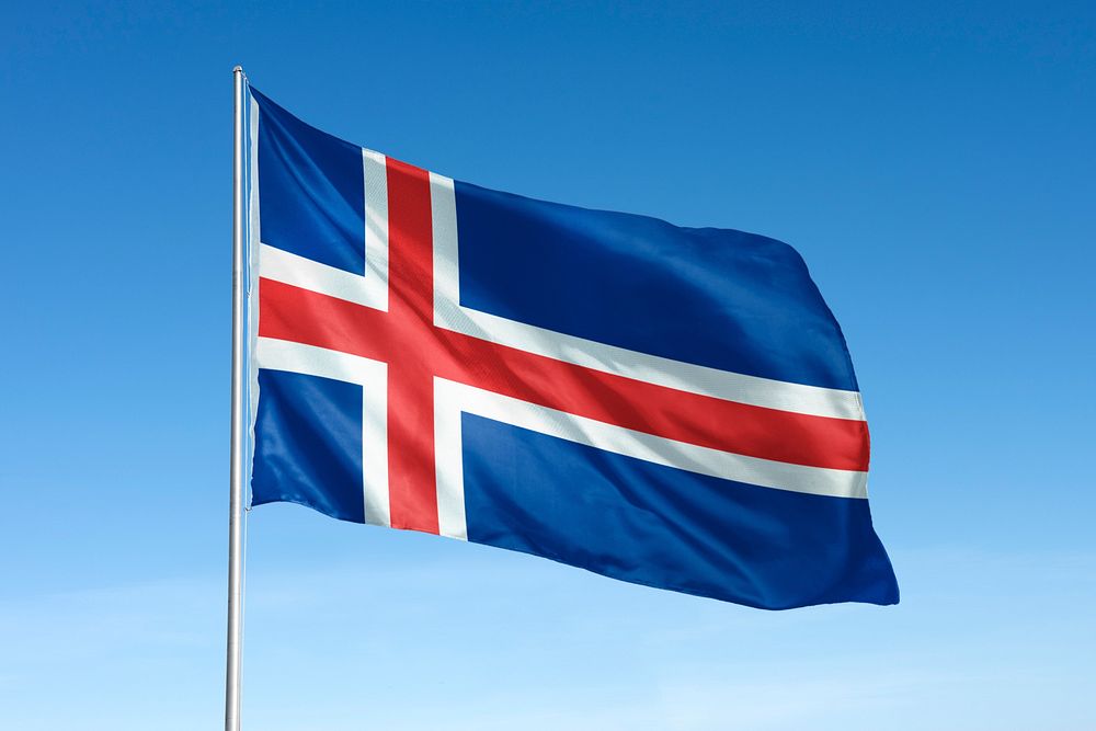 Waving Iceland flag, national symbol, blue sky