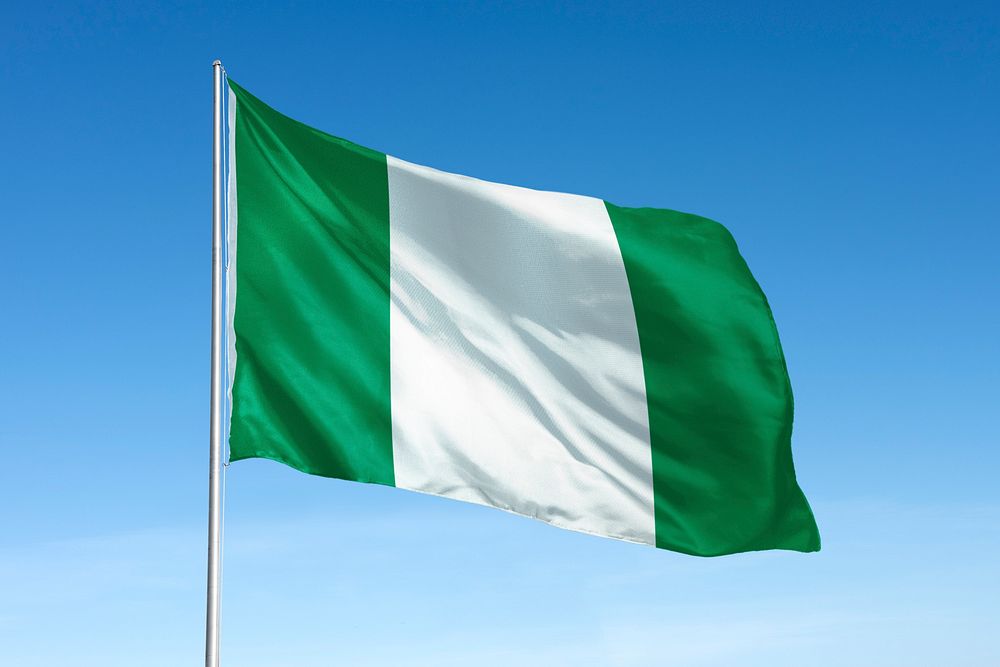 Waving Nigerian flag, national symbol, blue sky