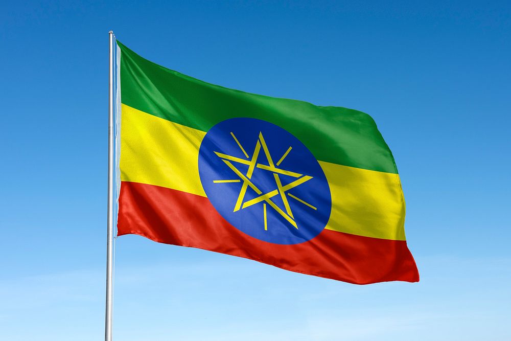 Waving Ethiopia flag, national symbol, blue sky
