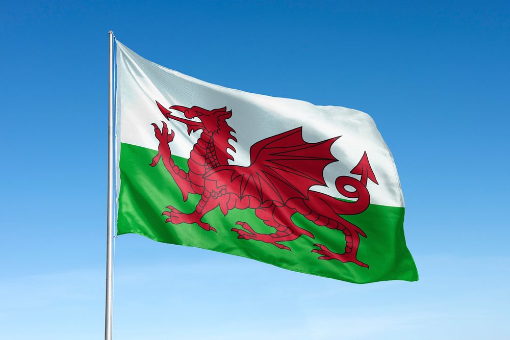 Waving Welsh flag, national symbol, blue sky
