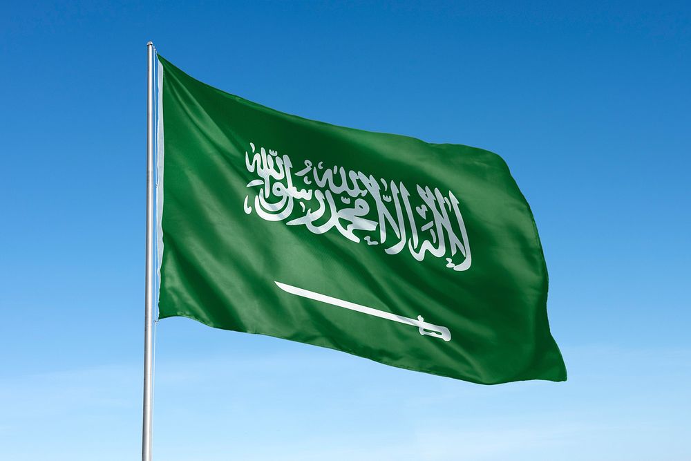 Waving Saudi Arabia flag, national symbol, blue sky