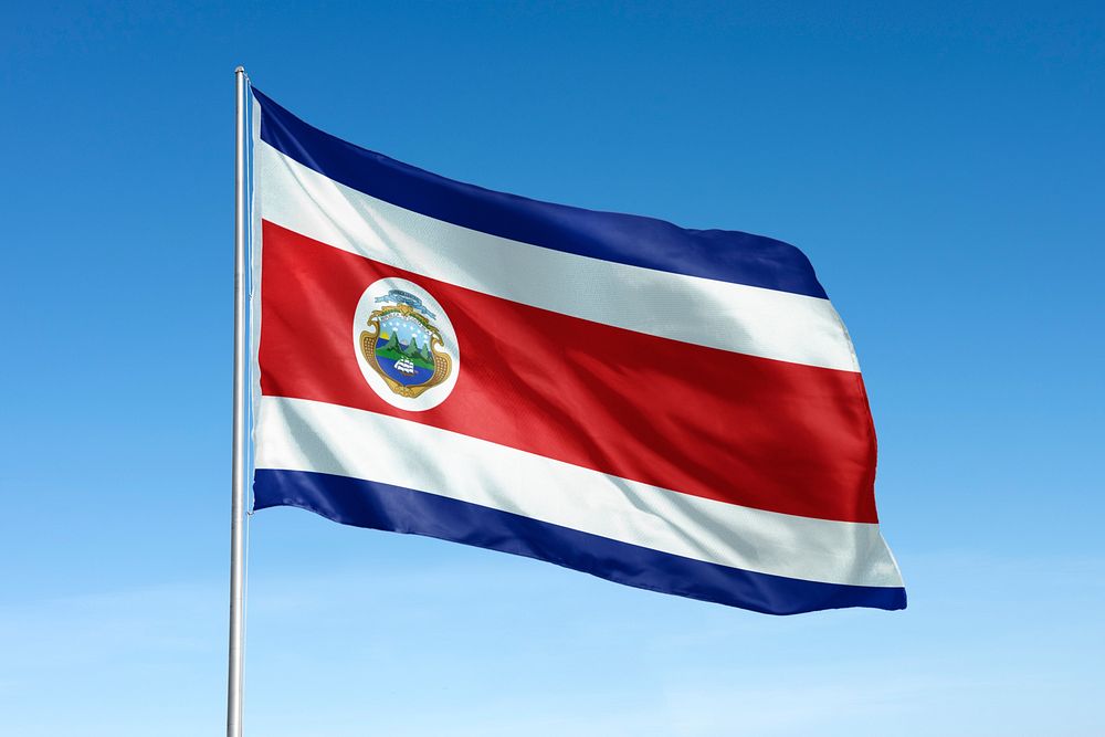Waving Costa Rica flag, national symbol, blue sky