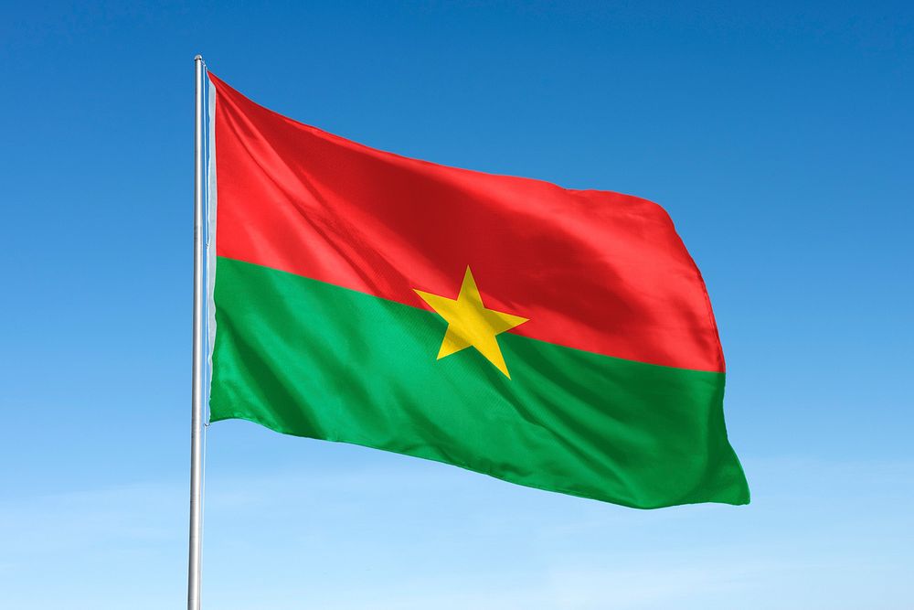 Waving Burkina Faso flag, national symbol, blue sky