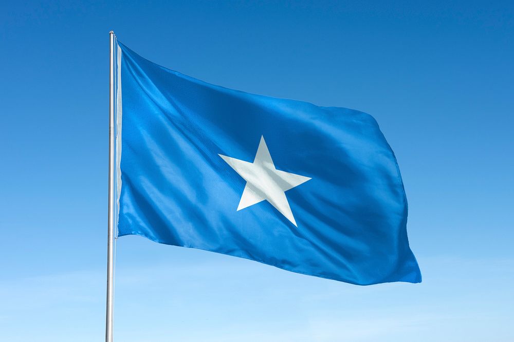 Waving Somalia flag, national symbol, blue sky