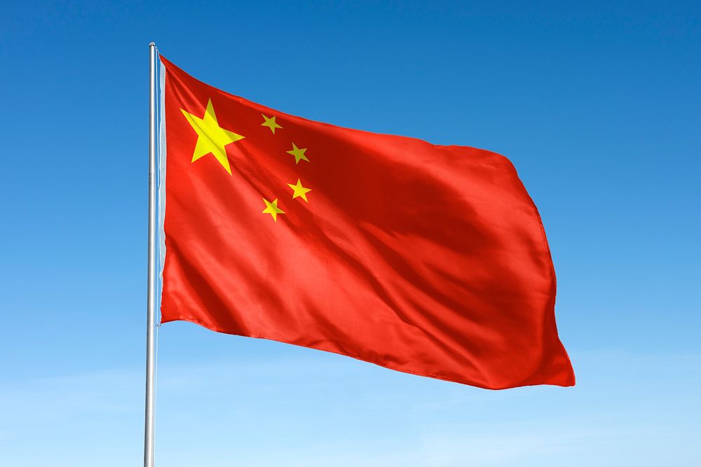 Waving China flag, national symbol, blue sky