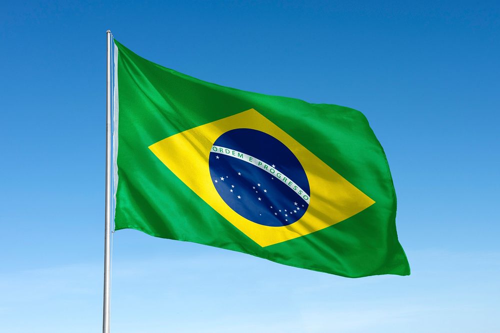 Waving Brazil flag, national symbol, blue sky