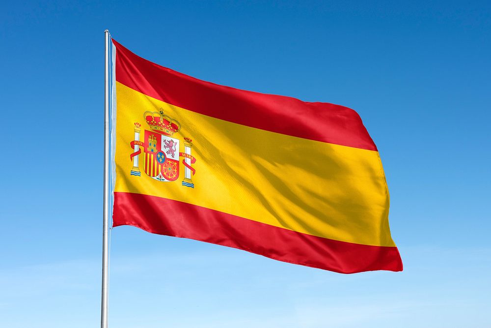 Waving Spain flag, national symbol, blue sky
