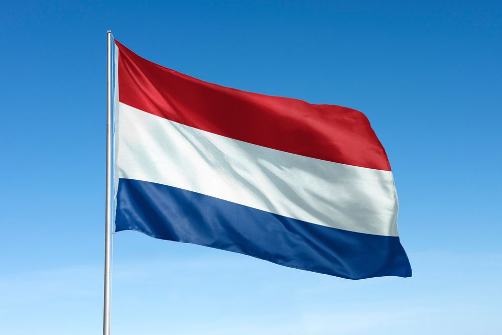 Waving Netherlands flag, national symbol, blue sky