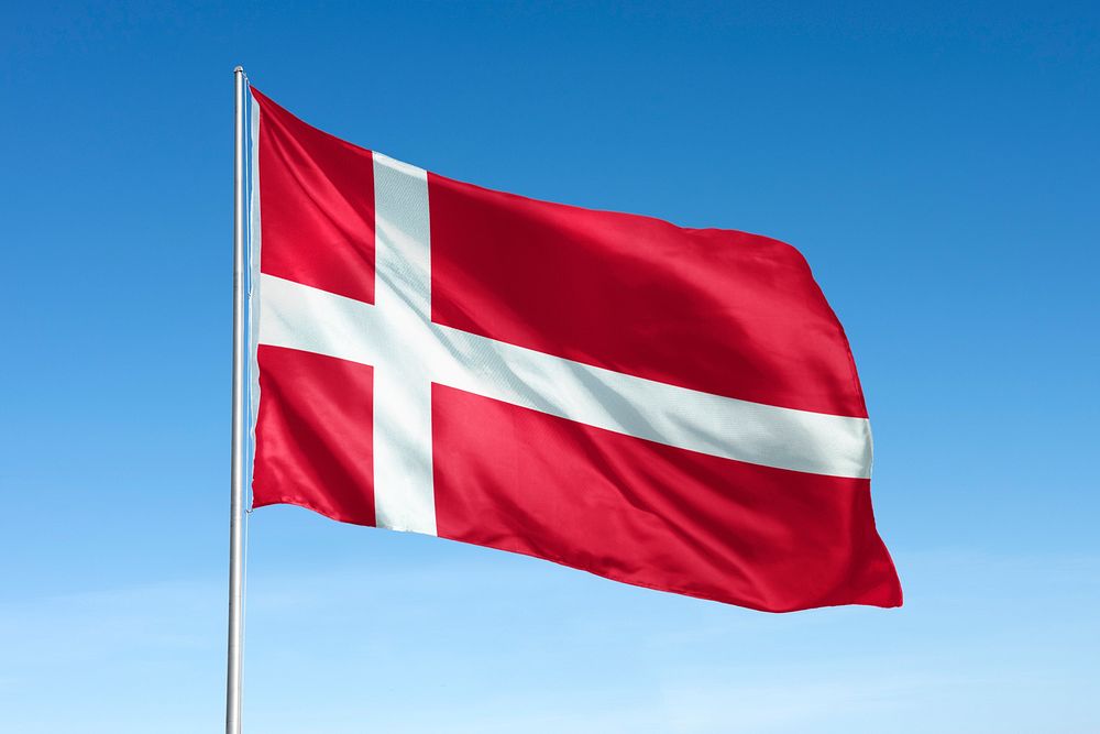 Waving Denmark flag, national symbol, blue sky
