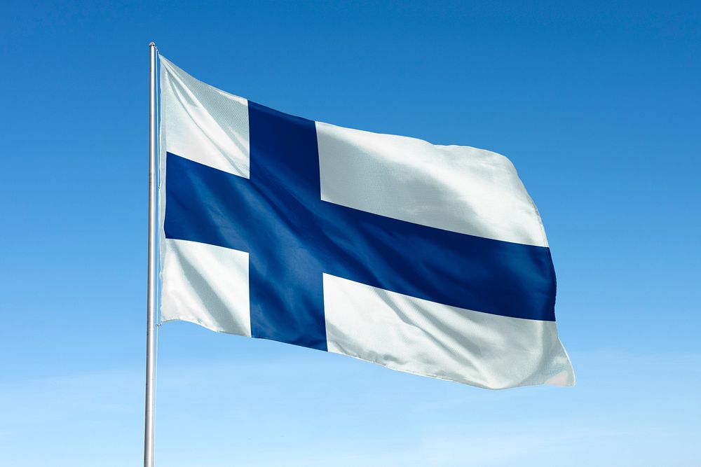 Waving Finland flag, national symbol, blue sky