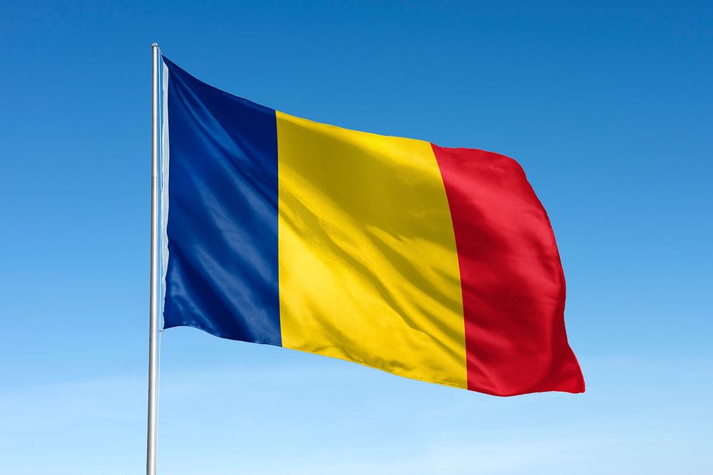 Waving Chad flag, national symbol, blue sky