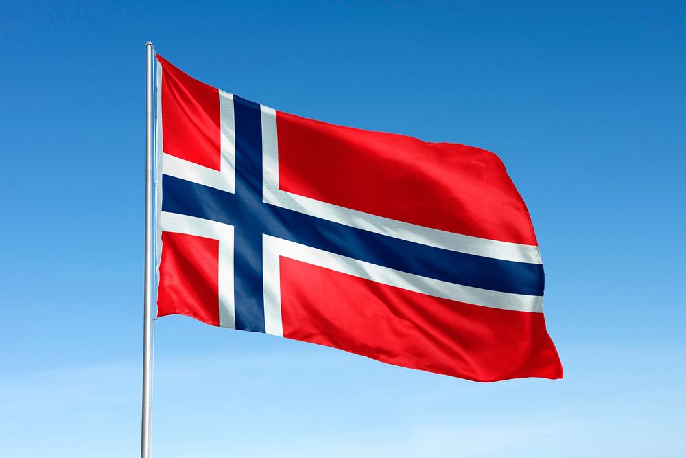 Waving Iceland flag, national symbol, blue sky
