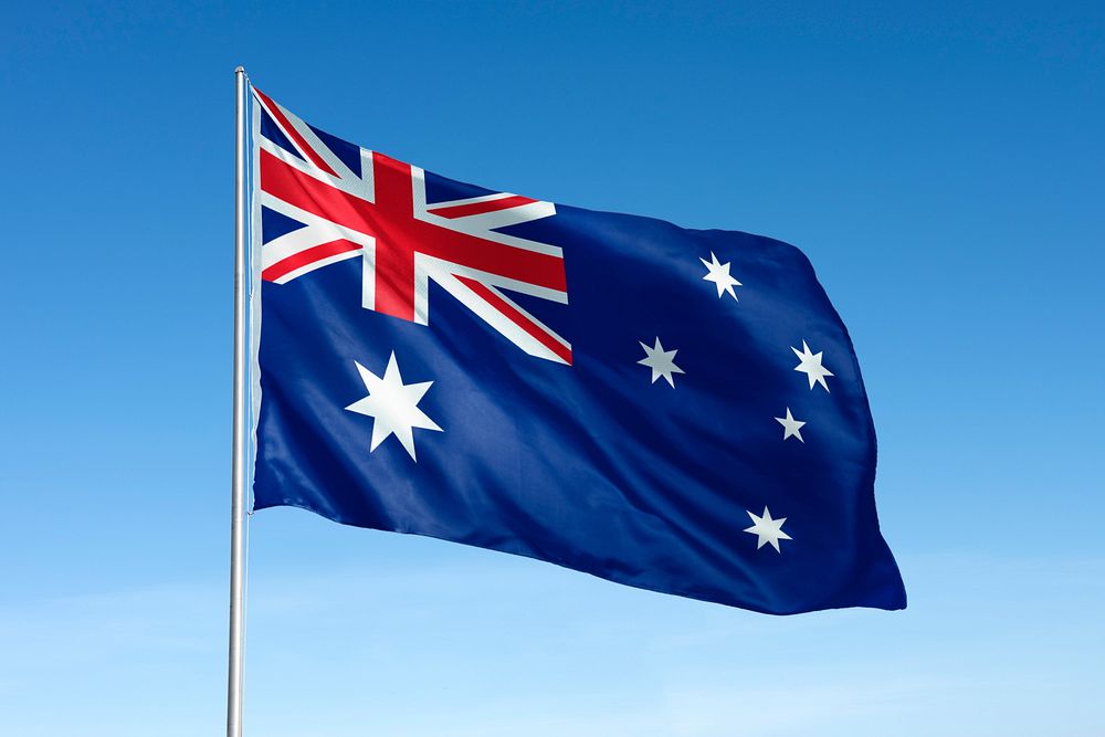 Waving Australia flag, national symbol, blue sky