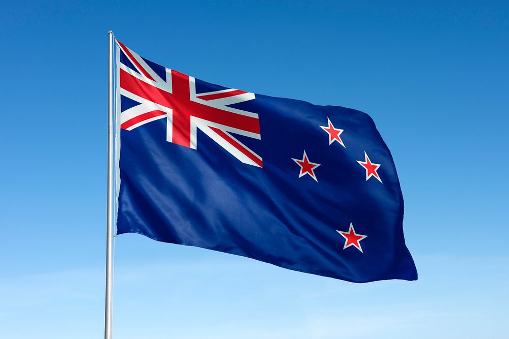 Waving New Zealand flag, national symbol, blue sky