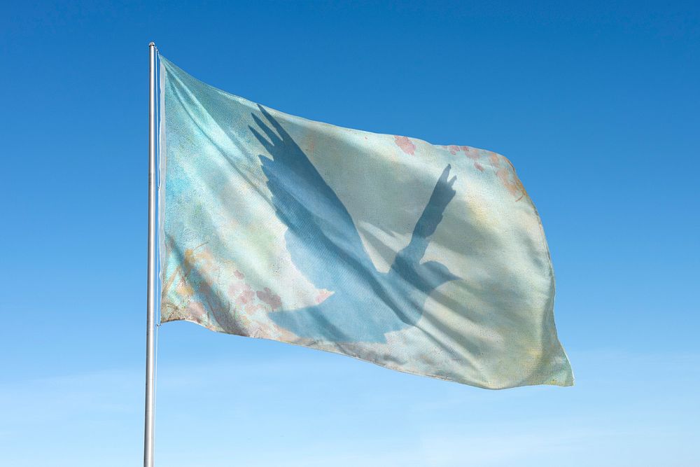 Waving Dove silhouette flag, blue sky