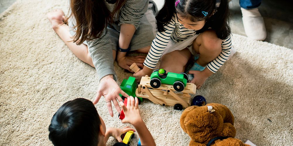 Japanese family playing with toys on the floor