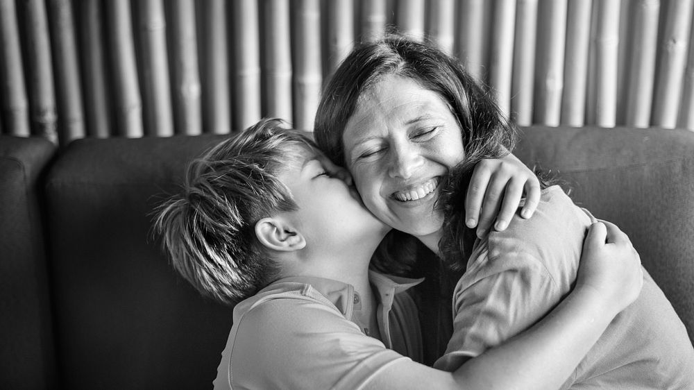 Young boy hugging and kissing his mom