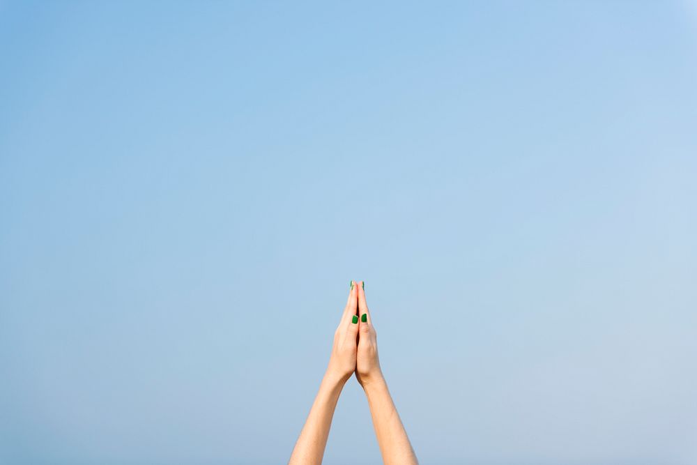 Praying hands pointed towards the sky, yoga excercise and stretching concept