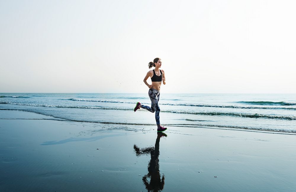 A woman is running at the beach