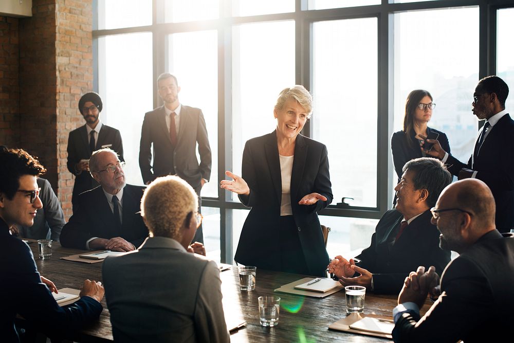 Business woman talking to colleagues in a meeting