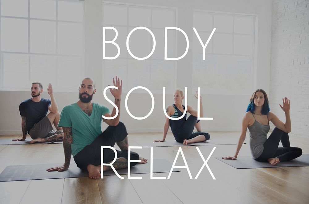 Group of people training in yoga class for body soul and mind relief