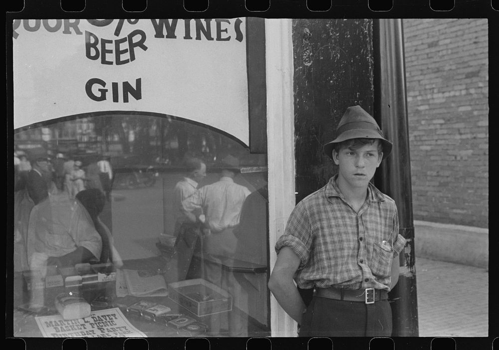Boy in front of liquor store, Newark, Ohio. Sourced from the Library of Congress.