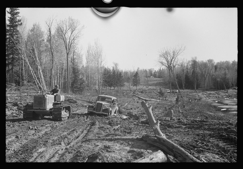 [Untitled photo, possibly related to: FSA (Farm Security Administration) photographer being pulled out of mud by tractor…