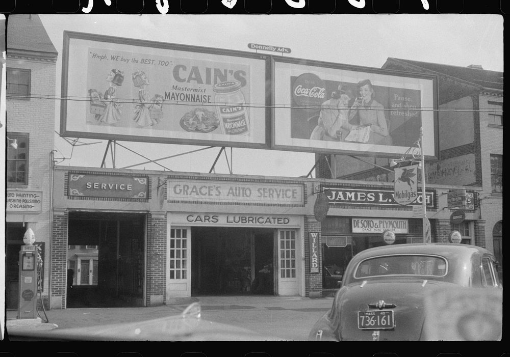 Garage and signs on street, Portsmouth, New Hampshire. Sourced from the Library of Congress.