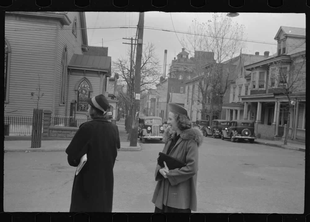 Shenandoah(?), Pennsylvania. Two women on a street corner, near a Protestant church, on Sunday morning. Sourced from the…