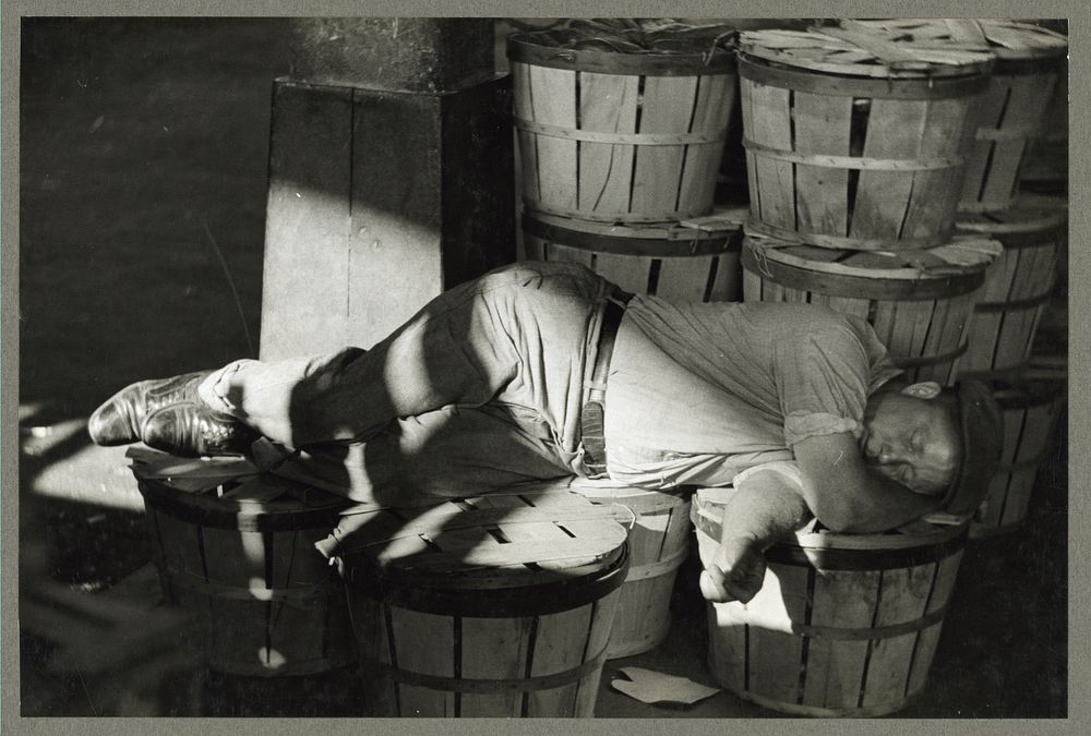 Man sleeping in fish market. Baltimore, Maryland. Sourced from the Library of Congress.