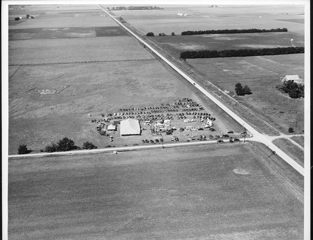 Airview of REA (Rural Electrification Administration) farm equipment tour. Kansas, Illinois. Sourced from the Library of…